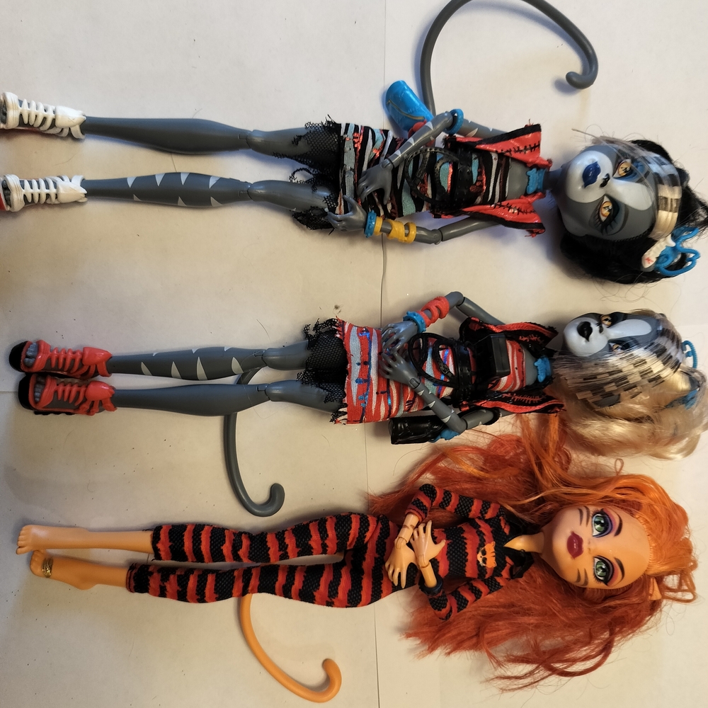monster high dolls with gray, black, orange and red accents